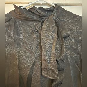 Silk black top. With a tie around the neck